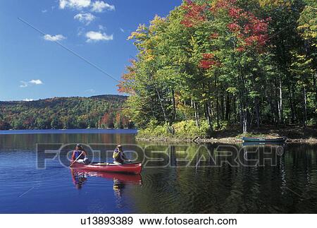 canoeing, canoe, Vermont, VT, Mother and daughter paddle a red canoe on Green River Reservoir in Hyde Park in the fall. View Large Photo Image Stock Photo - canoeing, canoe, Vermont, VT, Mother and daughter paddle a red canoe on Green River Reservoir in Hyde Park in the fall. . Fotosearch