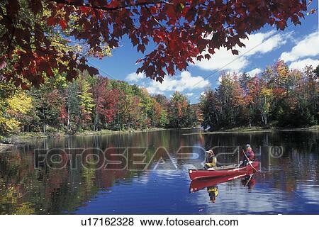 canoeing, canoe, Vermont, VT, Mother and daughter paddle a red canoe on the calm water of Green River Reservoir in Hyde Park in the fall. View Large Photo Image Stock Photo - canoeing, canoe, Vermont, VT, Mother and daughter paddle a red canoe on the calm water of Green River Reservoir in Hyde Park in the fall. . Fotosearch