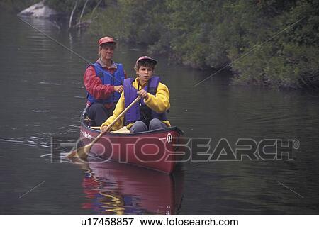 canoeing, canoe, Vermont, VT, Mother and daughter paddle a red canoe on Kettle Pond in Groton State Forest. View Large Photo Image Stock Photo - canoeing, canoe, Vermont, VT, Mother and daughter paddle a red canoe on Kettle Pond in Groton State Forest.. Fotosearch