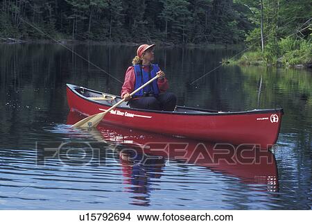 canoeing, canoe, Vermont, VT, Woman paddling a red canoe on Green River Reservoir in Hyde Park. View Large Photo Image Picture - canoeing, canoe, Vermont, VT, Woman paddling a red canoe on Green River Reservoir in Hyde Park. . Fotosearch