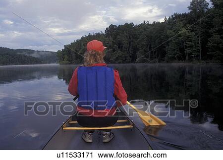 canoeing, canoe, Vermont, VT, Woman paddling a red canoe on Green River Reservoir in Hyde Park. View Large Photo Image Stock Image - canoeing, canoe, Vermont, VT, Woman paddling a red canoe on Green River Reservoir in Hyde Park. . Fotosearch