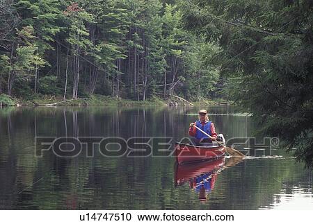 canoeing, canoe, Vermont, VT, Woman paddling a red canoe on Green River Reservoir in Hyde Park. View Large Photo Image Stock Image - canoeing, canoe, Vermont, VT, Woman paddling a red canoe on Green River Reservoir in Hyde Park. . Fotosearch