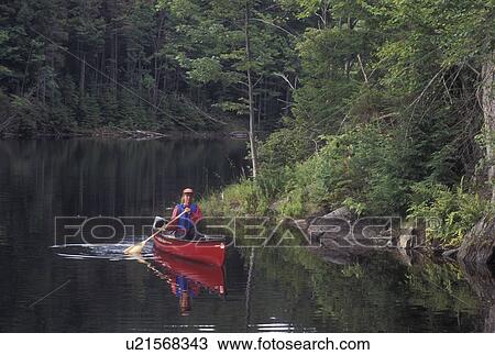 canoeing, canoe, Vermont, VT, Woman paddling a red canoe on Green River Reservoir in Hyde Park. View Large Photo Image Stock Image - canoeing, canoe, Vermont, VT, Woman paddling a red canoe on Green River Reservoir in Hyde Park. . Fotosearch