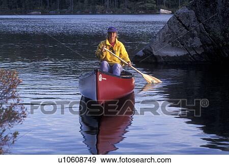 canoeing, canoe, Vermont, VT, Woman paddles a red canoe on Kettle Pond in Groton State Forest in the fall. View Large Photo Image Stock Photo - canoeing, canoe, Vermont, VT, Woman paddles a red canoe on Kettle Pond in Groton State Forest in the fall. . Fotosearch