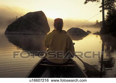 canoeing, canoe, Vermont, VT, Woman paddling a canoe on Kettle Pond through boulders in the fog in Groton State Forest. View Large Photo Image Stock Photograph - canoeing, canoe, Vermont, VT, Woman paddling a canoe on Kettle Pond through boulders in the fog in Groton State Forest.. Fotosearch