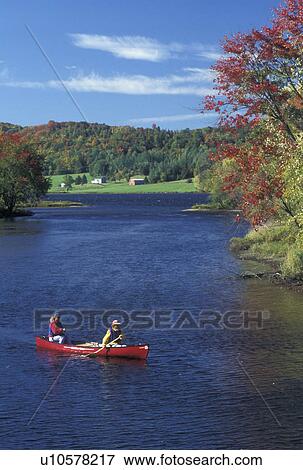 canoeing, Vermont, VT, Scenic view of mother and daughter paddling a red canoe down Clyde River in Charleston in the fall. View Large Photo Image Stock Photo - canoeing, Vermont, VT, Scenic view of mother and daughter paddling a red canoe down Clyde River in Charleston in the fall. . Fotosearch