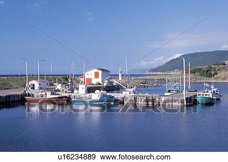 Stock Photo -  Cape Breton, Nova Scotia, NS, Canada, Fishing boats docked in harbor on Pleasant Bay on the Gulf of St. Lawrence in Cape Breton. . Fotosearch