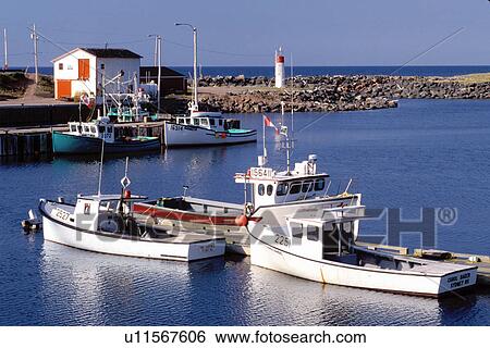 Stock Photograph -  Cape Breton, Nova Scotia, NS, Canada, Fishing boats docked in harbor on Pleasant Bay on the Gulf of St. Lawrence in Cape Breton. . Fotosearch