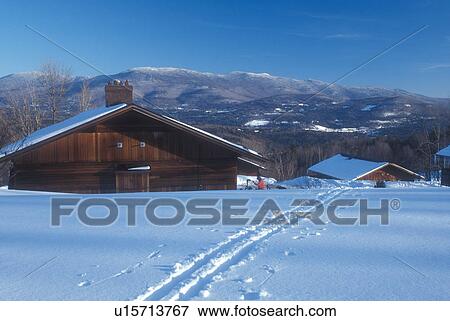 Stock Photo -  chalet, Trapp Family Lodge, lodging, TFL, Stowe, Vermont, VT, Guest houses at the Trapp Family Lodge overlook the scenic mountains in Stowe in the winter.. Fotosearch