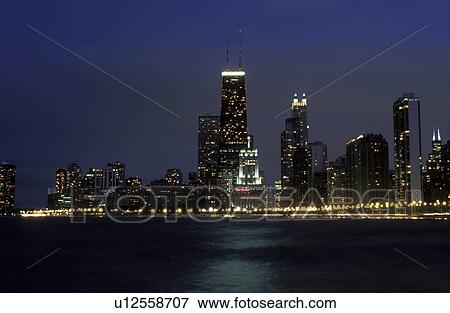 Stock Photo -  Chicago, skyline, evening, Illinois, IL, Lake Michigan, Downtown skyline of Chicago from Lake Shore Park in the evening on Lake Michigan.. Fotosearch