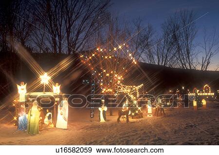 Stock Photo -  Christmas Postcard, decorations, nativity scene, christmas, holiday, outdoor, snow, winter, A Nativity scene and lights decorate a home at night in Richmond for the Christmas holiday season in Chittenden County in the state of Vermont.. Fotosearch