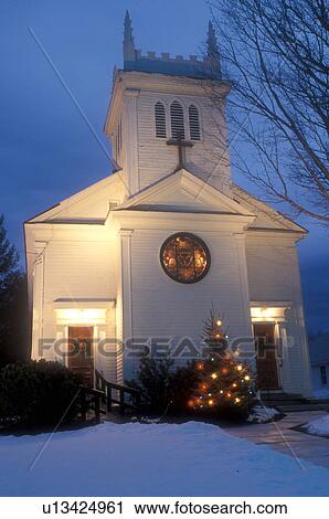Stock Image -  church, chapel, Christmas, winter, Vermont, Christmas lights decorate the Christmas tree outside the Mount Zion Church on a snow covered night in Manchester in winter in Bennington County in the state of Vermont. . Fotosearch