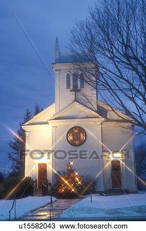 Stock Image -  church, chapel, Christmas, winter, Vermont, Christmas starlights decorate the Christmas tree outside the Mount Zion Church on a snow covered night in Manchester in winter in Bennington County in the state of Vermont. . Fotosearch