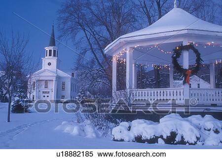 Stock Photography -  church, gazebo, chapel, Christmas, decorations, holiday, winter scene, snow, town, Vermont, The First Baptist Church and Gazebo on the Green are decorated for the Christmas holiday season on a snow covered night in the village of Bristol in Addison Count. Fotosearch