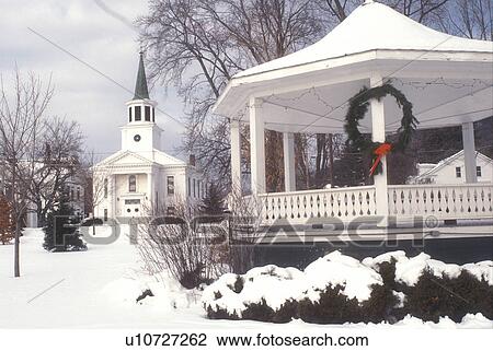 Stock Image -  church, gazebo, Christmas, chapel, decorations, holiday, winter scene, village, town, snow, Vermont, The First Baptist Church and Gazebo on the Green are decorated for the Christmas holiday season on a snow covered day in the village of Bristol in Addiso. Fotosearch