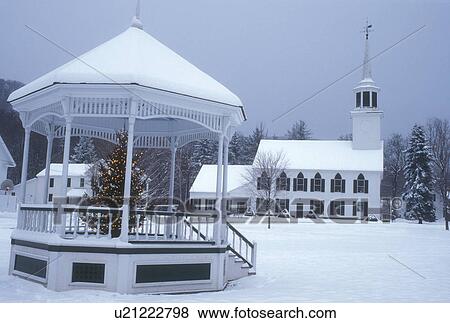 Stock Photo -  church, winter scene, village, snow, Christmas, Vermont, Scenic view of the snow covered Townshend Church and gazebo with Christmas tree on the green on a gray winter day in the village of Townshend in Windham County in the state of Vermont. . Fotosearch