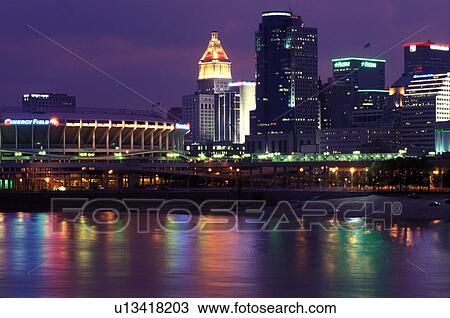 Stock Image -  Cincinnati, stadium, skyline, OH, Ohio, Cinergy Field, home of the Cincinnati Reds, and downtown skyline of Cincinnati across the Ohio River in the evening. . Fotosearch