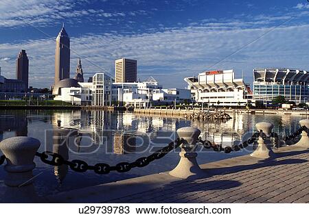 Stock Image -  Cleveland, OH, Ohio, Skyline of downtown Cleveland and Cleveland Browns Stadium along the waterfront of North Coast Harbor.. Fotosearch