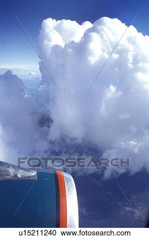 Stock Image -  clouds, aerial, airplane, American West Airlines plane flies over the Southern Rockies.. Fotosearch