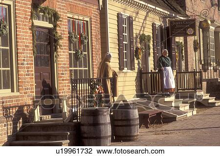Colonial Williamsburg, Virginia, VA, Williamsburg, Interpreters wearing colonial costumes stand outside the village stores in Colonial Williamsburg. View Large Photo Image Stock Image - Colonial Williamsburg, Virginia, VA, Williamsburg, Interpreters wearing colonial costumes stand outside the village stores in Colonial Williamsburg.. Fotosearch