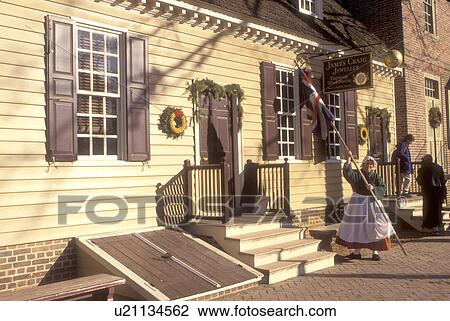 Colonial Williamsburg, Virginia, VA, Williamsburg, Interpreters wearing colonial costumes stand outside the village stores in Colonial Williamsburg. View Large Photo Image Stock Image - Colonial Williamsburg, Virginia, VA, Williamsburg, Interpreters wearing colonial costumes stand outside the village stores in Colonial Williamsburg.. Fotosearch