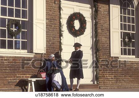 Colonial Williamsburg, Virginia, VA, Williamsburg, Interpreters dressed in colonial costumes talk outside the Courthouse which is decorated with a Christmas wreath in Colonial Williamsburg. View Large Photo Image Stock Photo - Colonial Williamsburg, Virginia, VA, Williamsburg, Interpreters dressed in colonial costumes talk outside the Courthouse which is decorated with a Christmas wreath in Colonial Williamsburg.. Fotosearch