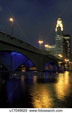 Stock Photography -  Columbus, skyline, OH, Ohio, Downtown skyline of Columbus along the Scioto River in the evening.. Fotosearch