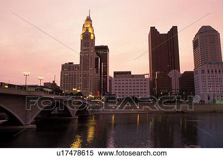 Stock Photography -  Columbus, skyline, OH, Ohio, Downtown skyline of Columbus along the Scioto River at sunrise.. Fotosearch