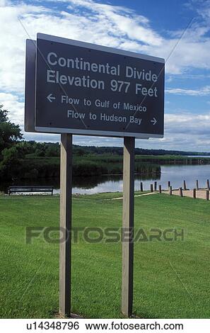 Stock Photograph -  Continental Divide, MN/SD, Minnesota, South Dakota, Minnesota River, Traverse Lake, Continental Divide sign in Browns Valley indicating the flow of the rivers to the Gulf of Mexico and to the Hudson Bay.. Fotosearch