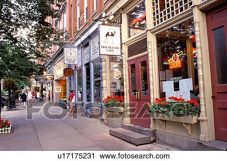 Stock Image -  Cooperstown, baseball, NY, New York, Shops along the main street in downtown Cooperstown.. Fotosearch