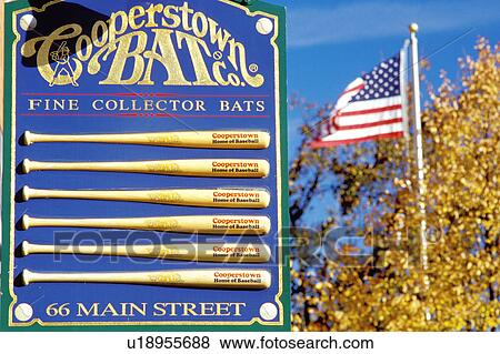 Cooperstown, New York, NY, Close-up of sign at Cooperstown Bat Company in downtown Cooperstown. Home of Baseball. American flag flies in the background. View Large Photo Image Stock Photo - Cooperstown, New York, NY, Close-up of sign at Cooperstown Bat Company in downtown Cooperstown. Home of Baseball. American flag flies in the background.. Fotosearch