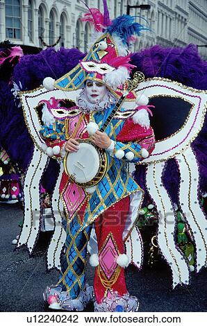 Stock Image -  costume, clown, parade, banjo, Philadelphia, PA, Pennsylvania, A member of a String Band dressed in an ornate court jester costume holds his banjo in the Mummers Day Parade on New Years Day in Philadelphia.. Fotosearch