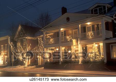 Stock Image -  country inn, inn, resort, hotel, B&B, ski resort, decorations, Christmas, holiday, village, evening, snow, Stowe, winter, Vermont, The Green Mountain Inn is decorated for the Christmas holiday season in the village of Stowe on a snow covered night in Lam. Fotosearch