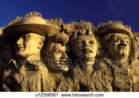 Stock Image -  Country Music, Branson, MO, Missouri, Famous peoples faces displayed like Mount Rushmore at the Hollywood Wax Museum in Branson.. Fotosearch