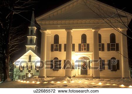 Stock Image -  courthouse, church, village, Christmas, decorations, Vermont, snow, winter, The Windham County Courthouse and the Congregational Church are illuminated for Christmas on a snow covered night in winter in the town of Newfane in Windham County in the state . Fotosearch