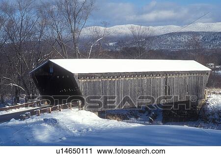Stock Image -  covered bridge, bridge, winter, Scenic view of Gorham or Goodnaugh Covered Bridge ca. 1841 on a sunny day in winter in Pittsford in Rutland County in the state of Vermont. . Fotosearch