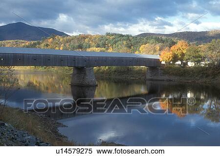 Stock Photography -  covered bridge, fall, river, Windsor, VT/NH, Vermont, New Hampshire, Scenic view of the Windsor/Cornish Covered Bridge reflecting in the calm Connecticut River in Windsor in autumn.. Fotosearch