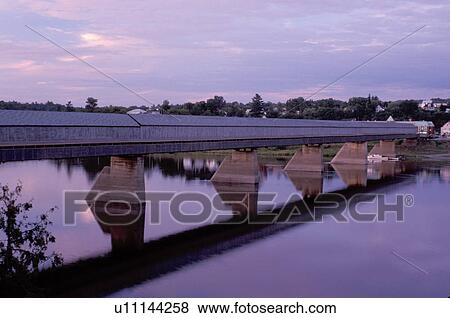 covered bridge, New Brunswick, Hartland, NB, Canada, World's Longest Covered Bridge (1282 ft. ) reflects in the calm water of St. John's River in the town of Hartland. View Large Photo Image Stock Photo - covered bridge, New Brunswick, Hartland, NB, Canada, World's Longest Covered Bridge (1282 ft. ) reflects in the calm water of St. John's River in the town of Hartland. . Fotosearch