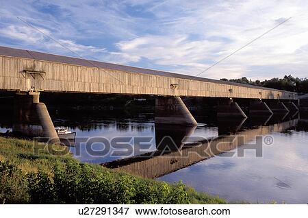 covered bridge, New Brunswick, Hartland, NB, Canada, World's Longest Covered Bridge (1282 ft. ) reflects in the calm water of St. John's River in the town of Hartland. View Large Photo Image Stock Photo - covered bridge, New Brunswick, Hartland, NB, Canada, World's Longest Covered Bridge (1282 ft. ) reflects in the calm water of St. John's River in the town of Hartland. . Fotosearch