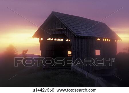 Stock Photograph -  covered bridge, sunset, fog, Cabot, VT, Vermont, Foster Covered Bridge in the fog at sunset in Cabot.. Fotosearch