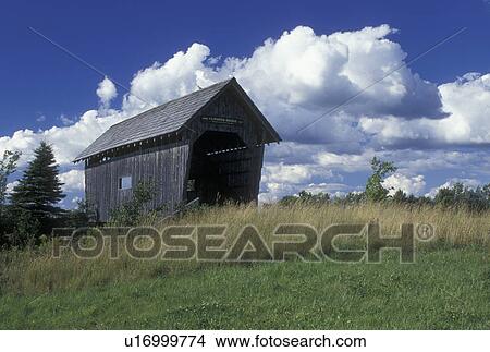 Picture -  covered bridge, Vermont, VT, Foster Covered Bridge with blue sky and white puffy clouds in Cabot.. Fotosearch