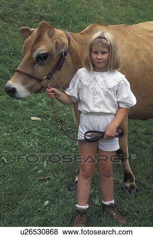 Stock Photo -  cow, Vermont, VT, Young girl poses with her prize cow at the The Tunbridge World's Fair in Tunbridge.. Fotosearch
