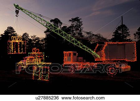 crane, Georgia, GA, Atlanta, Colorful Christmas lights decorate a large truck holding presents with a crane at Georgia's Stone Mountain Park. View Large Photo Image Stock Photograph - crane, Georgia, GA, Atlanta, Colorful Christmas lights decorate a large truck holding presents with a crane at Georgia's Stone Mountain Park.. Fotosearch