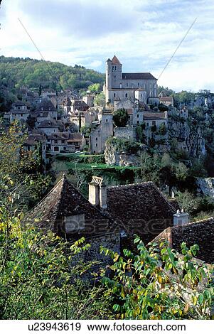 Stock Photo -  Dordogne, Perigord, France, Quercy, Midi-Pyrenees, Lot, Europe, Saint Cirq-Lapapie, A medieval castle and village of Saint Cirq-Lapapie sit above the rocky cliffs. . Fotosearch