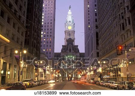 Stock Photo -  downtown, City Hall, Philadelphia, Pennsylvania, PA, Christmas decorations along Broad Street and view of City Hall at Center Square in downtown Philadelphia in the evening.. Fotosearch
