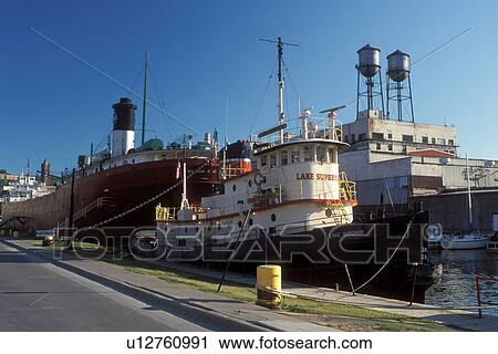 Stock Image -  Duluth, MN, Minnesota, Tugboat and the William A. Irwin Ore Boat moored at the dock in Duluth Harbor on Lake Superior in Duluth.. Fotosearch