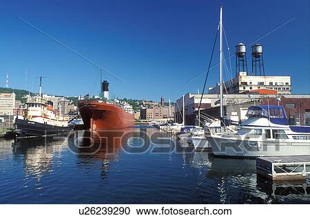 Stock Image -  Duluth, MN, Minnesota, Tugboat and the William A. Irwin Ore Boat moored at the dock in Duluth Harbor on Lake Superior in Duluth.. Fotosearch