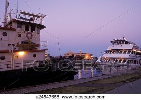 Duluth, MN, Minnesota, Vista Fleet/Duluth-Superior Excursion boat and tugboat moored at the dock in the evening in Duluth Harbor on Lake Superior in Duluth. View Large Photo Image Stock Photo - Duluth, MN, Minnesota, Vista Fleet/Duluth-Superior Excursion boat and tugboat moored at the dock in the evening in Duluth Harbor on Lake Superior in Duluth.. Fotosearch