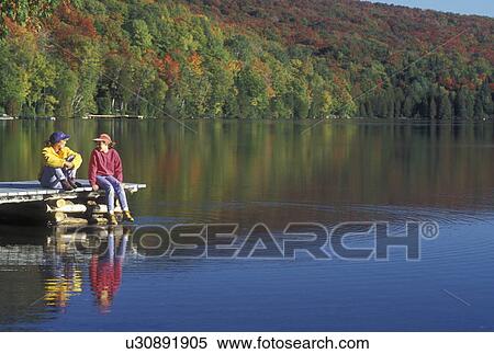 fall, lake, Westmore, VT, Vermont, Mother and daughter sitting together and talking on a dock on Long Pond in the autumn. View Large Photo Image Stock Photography - fall, lake, Westmore, VT, Vermont, Mother and daughter sitting together and talking on a dock on Long Pond in the autumn.. Fotosearch