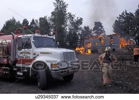 fire, Vermont, VT, Fireman walks back to firetruck while a house is on fire in Berlin. View Large Photo Image Stock Photo - fire, Vermont, VT, Fireman walks back to firetruck while a house is on fire in Berlin.. Fotosearch